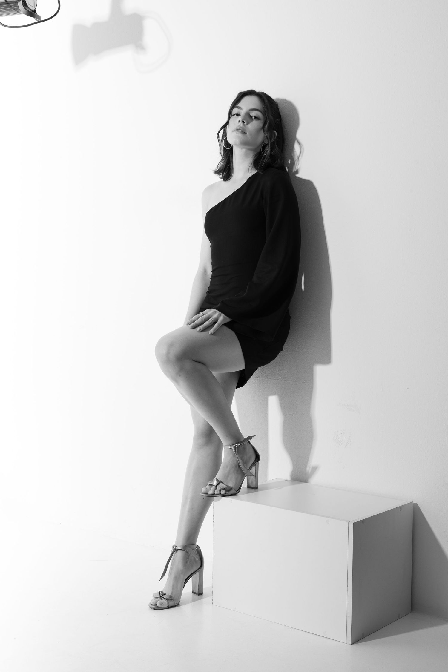 Black and white fashion portraits with geometric shapes and dramatic shadows.