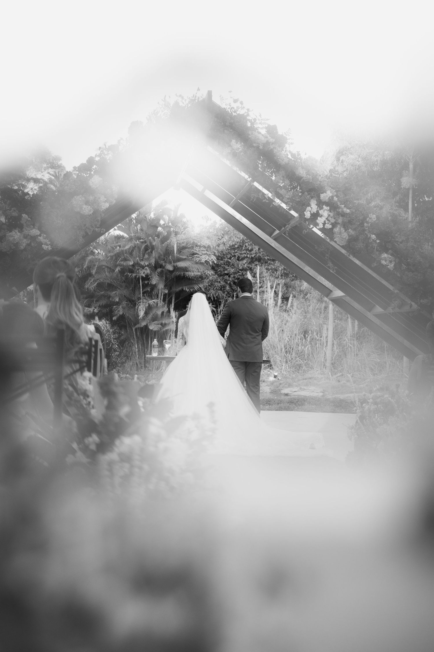 Dreamy black and white wedding photos with soft focus and natural lighting outdoors.