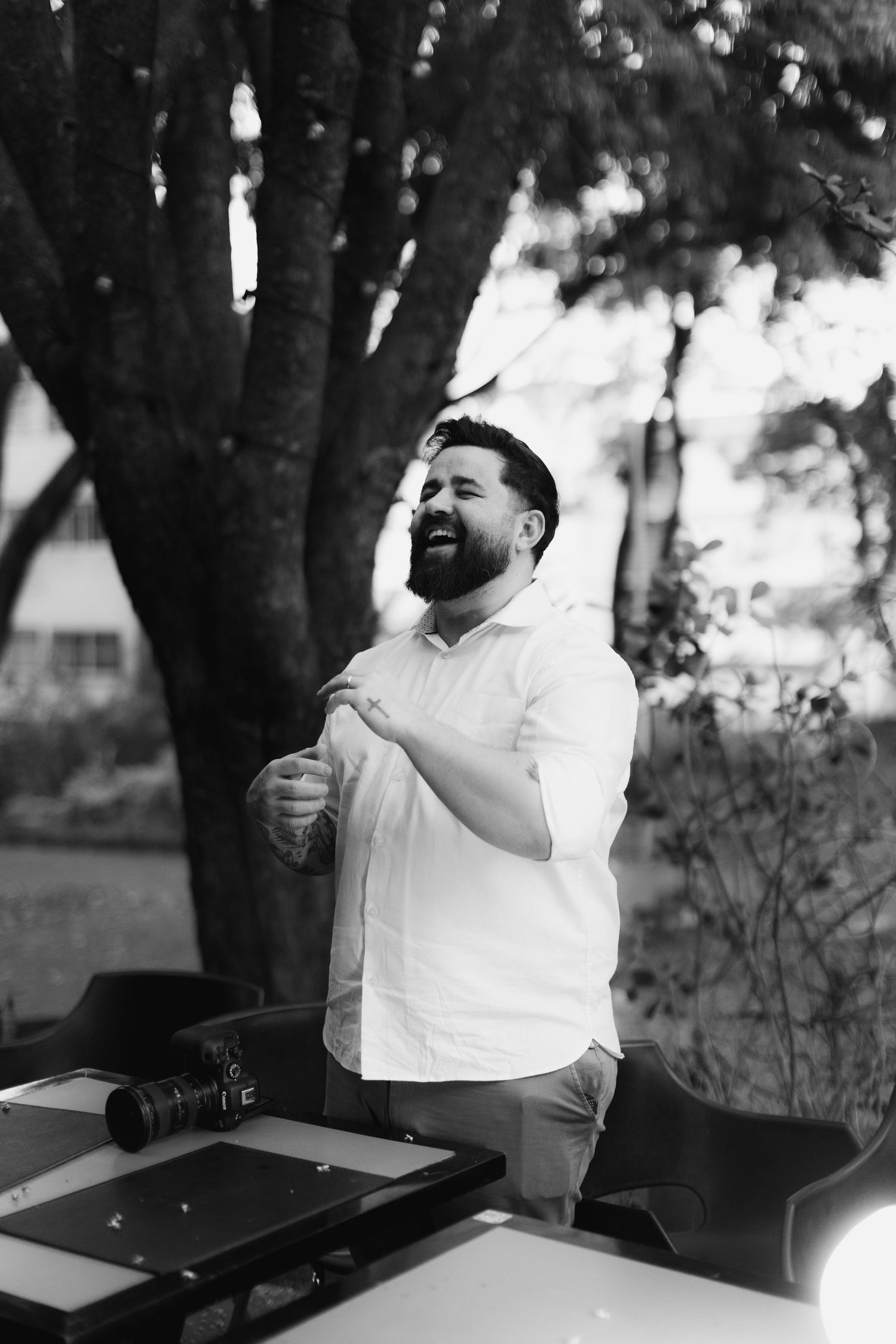 Black and white portrait series showing joyful expressions in an outdoor setting.