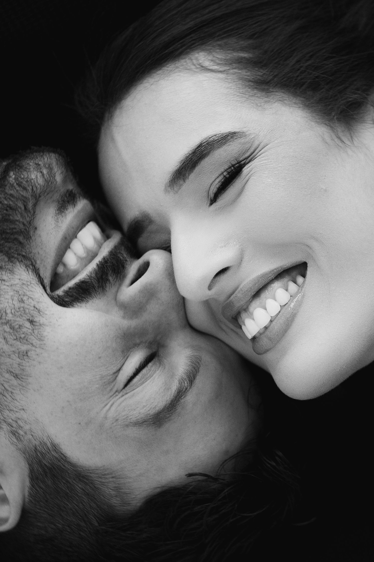 Intimate black and white close-up portraits showing expressions of joy.