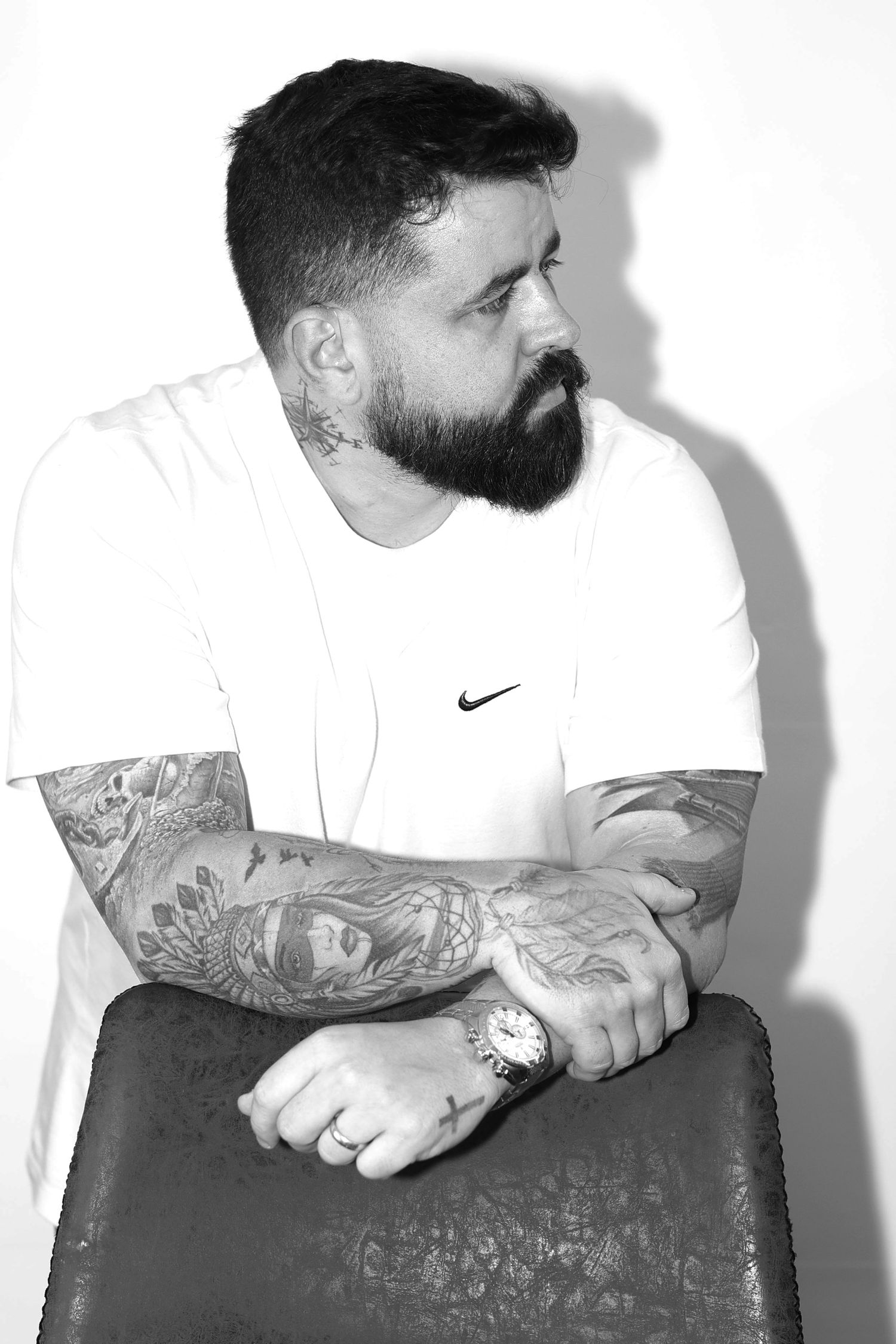 Black and white series showing tattooed arms and casual attire against white background.