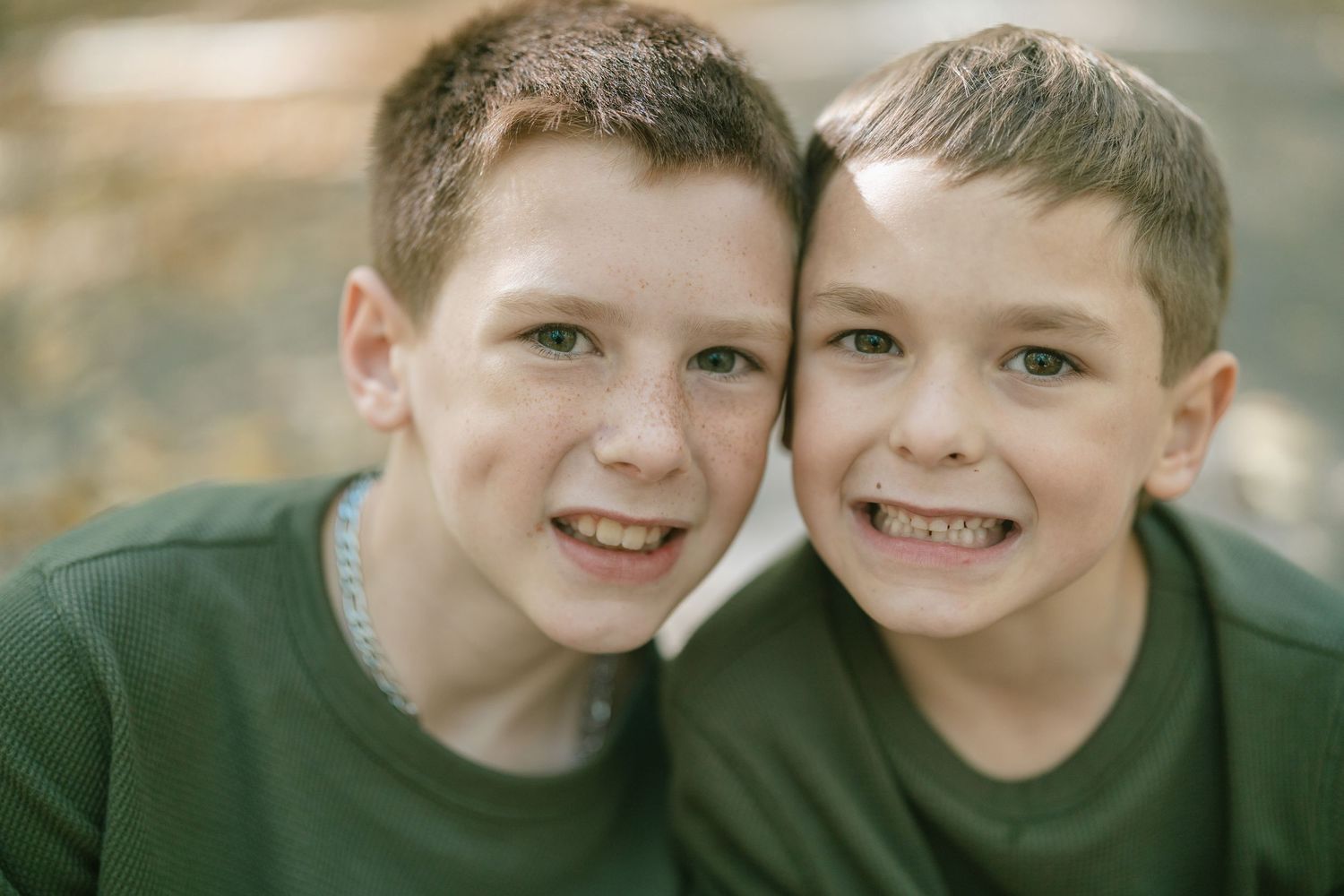 Close-up portraits showing joyful expressions in matching green shirts.