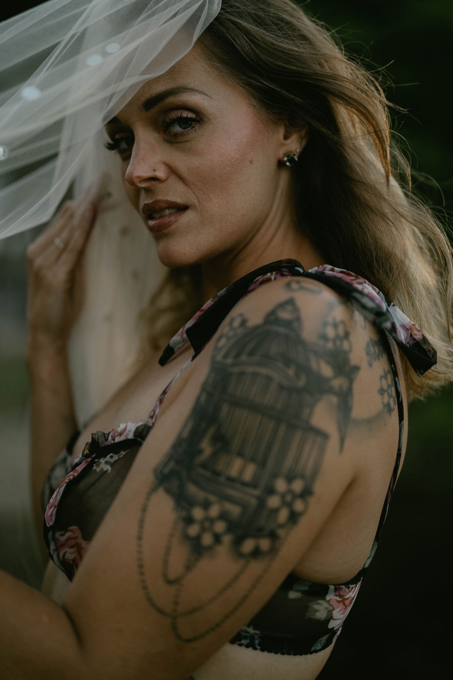 Close-up shots highlighting detailed tattoo artwork in moody natural lighting.