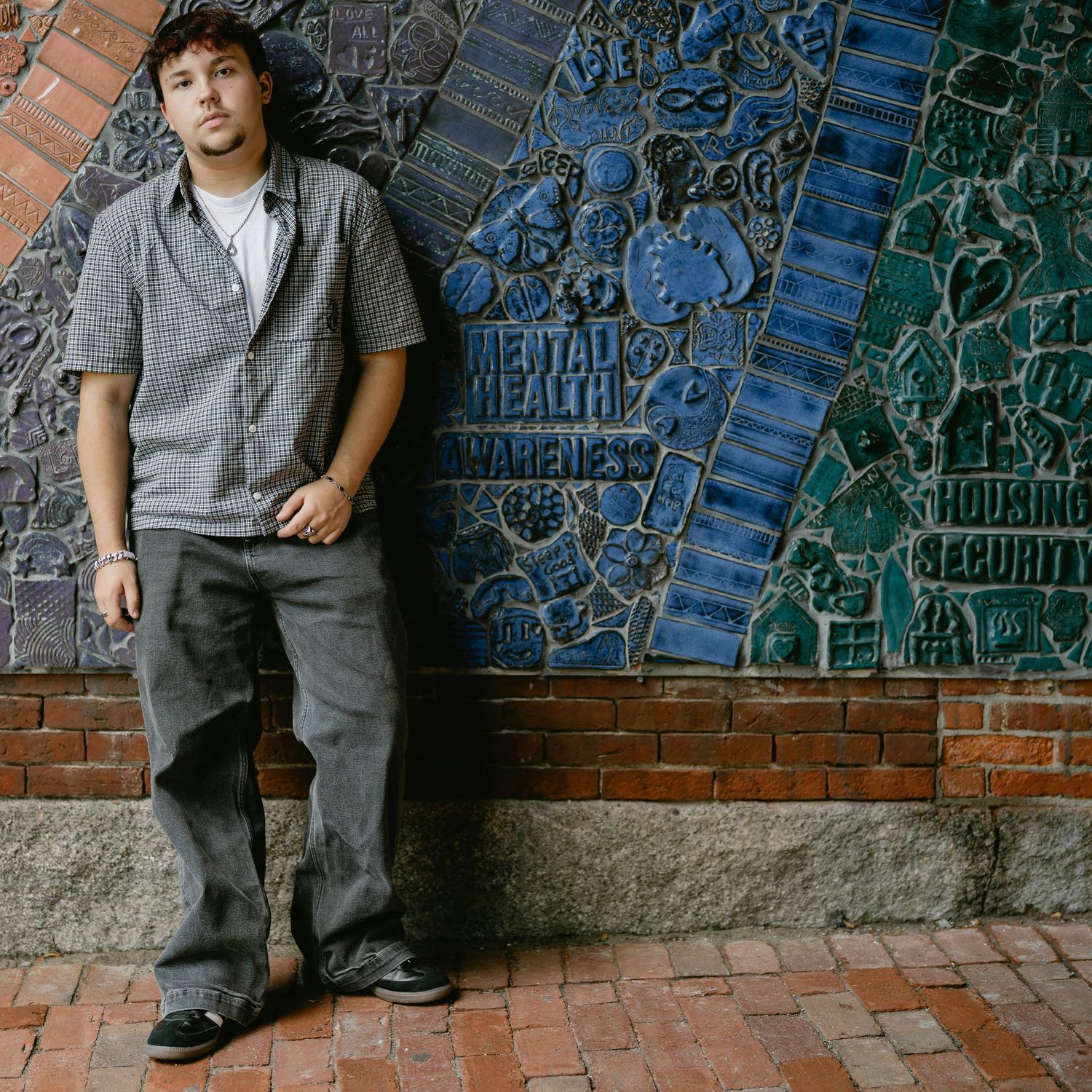 Senior posing near colorful mural, showing personality and style in city session.