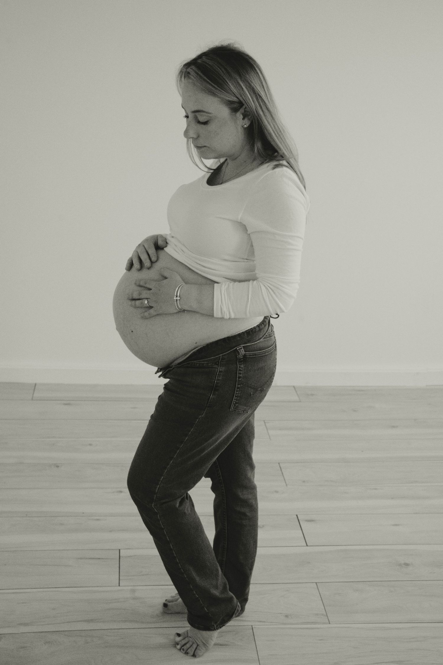 Black and white maternity portraits showing side profile poses.