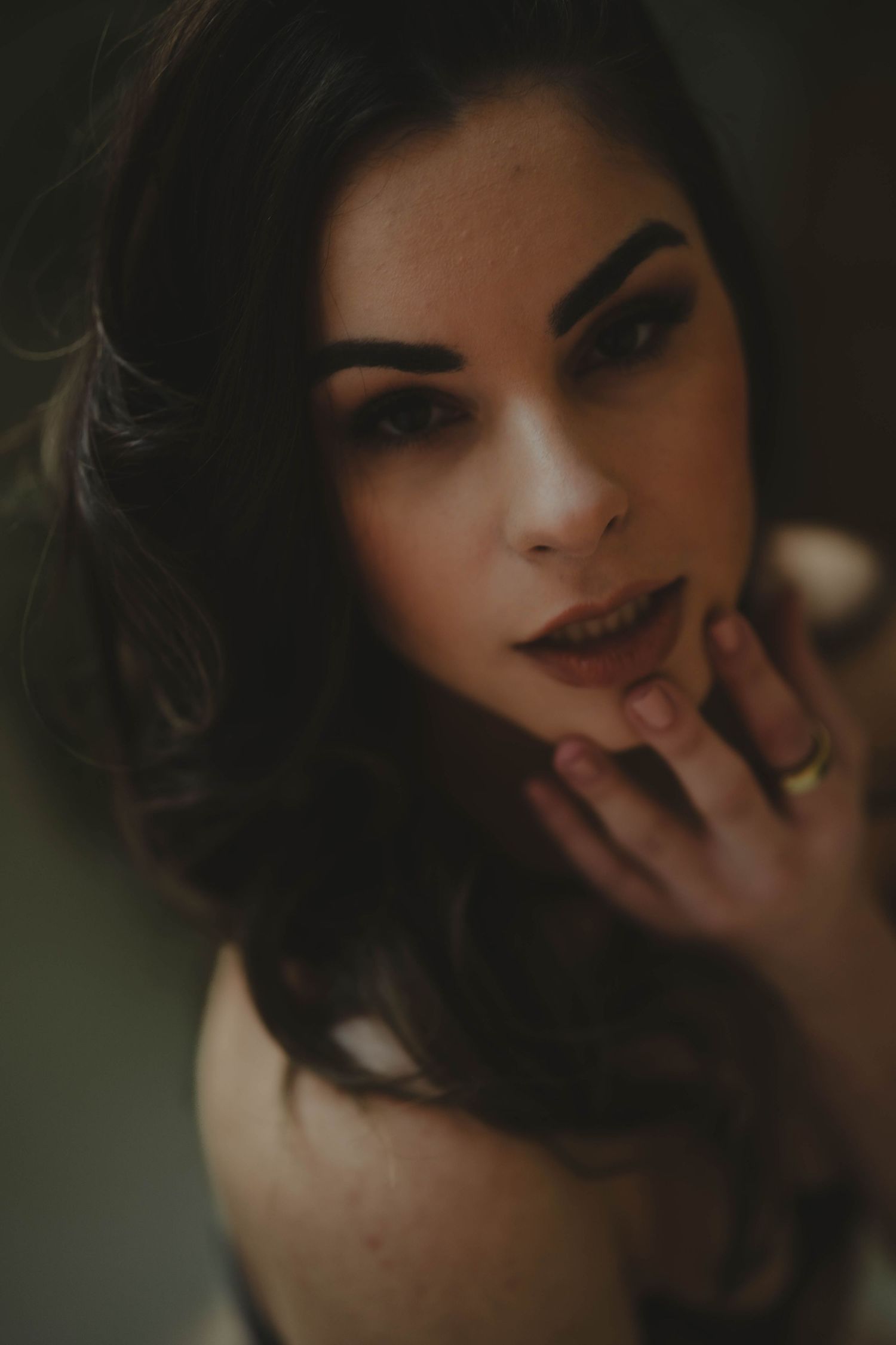 A moody portrait series showing close-up expressions in dark, atmospheric lighting.