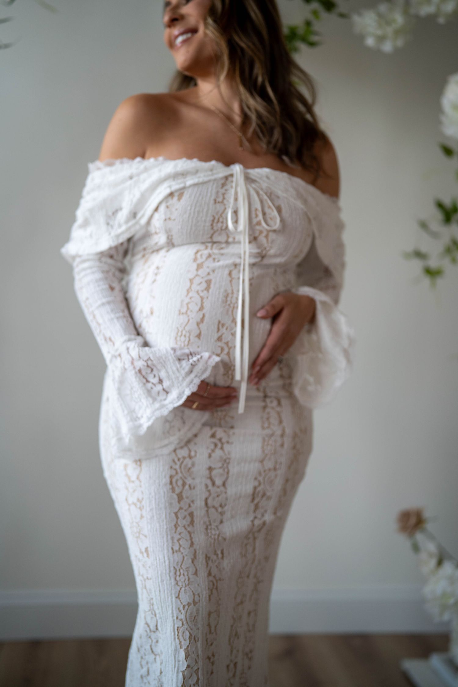 A delicate white lace dress with off-shoulder detail shown in multiple close-up shots.