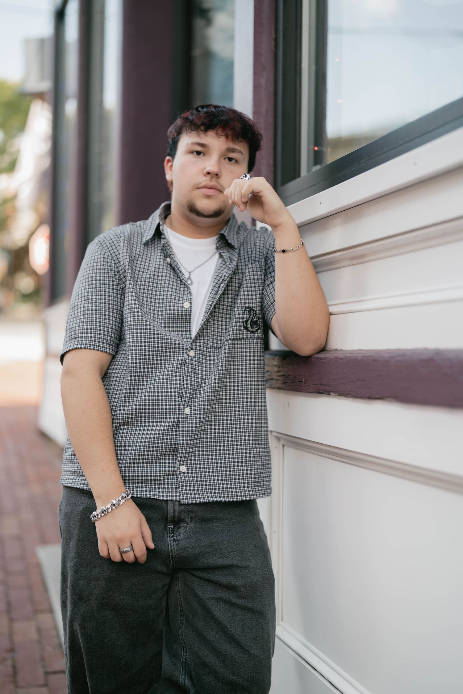 Senior posing near colorful mural, showing personality and style in city session.
