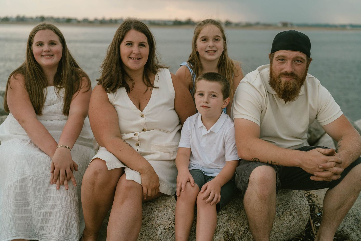 Parents and kids walking hand-in-hand through a leafy trail, enjoying a relaxed family photo session.