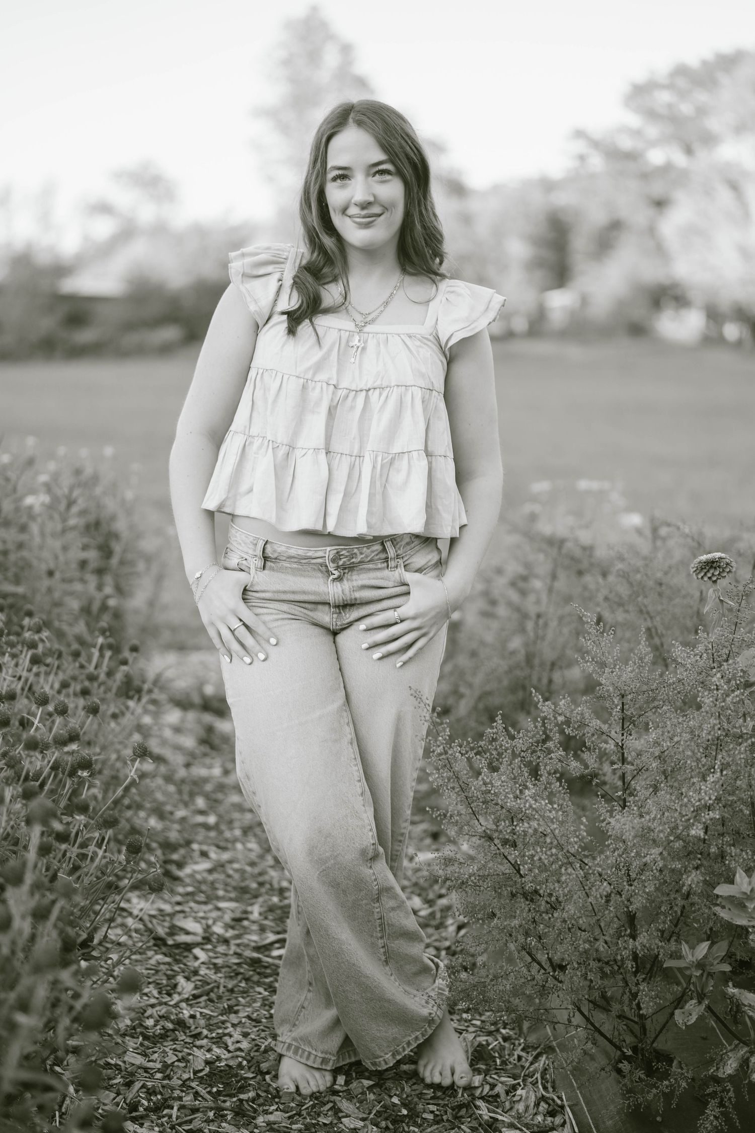 Black and white outdoor portrait session in a flowering meadow.