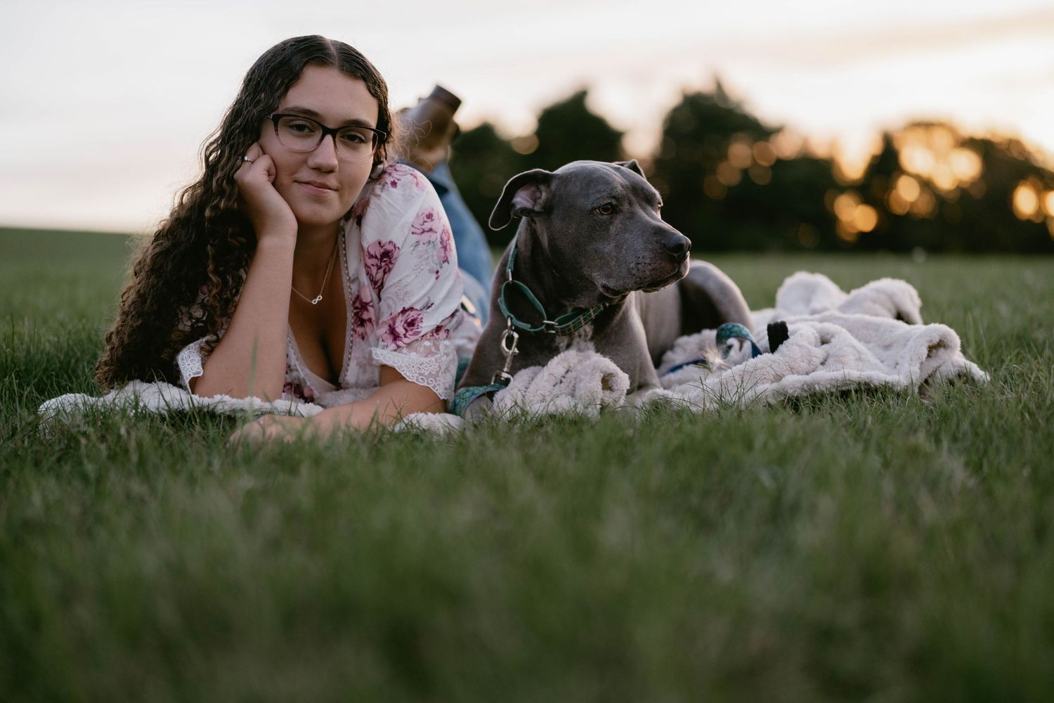 Senior lying in field with puppy, relaxed and joyful moment.