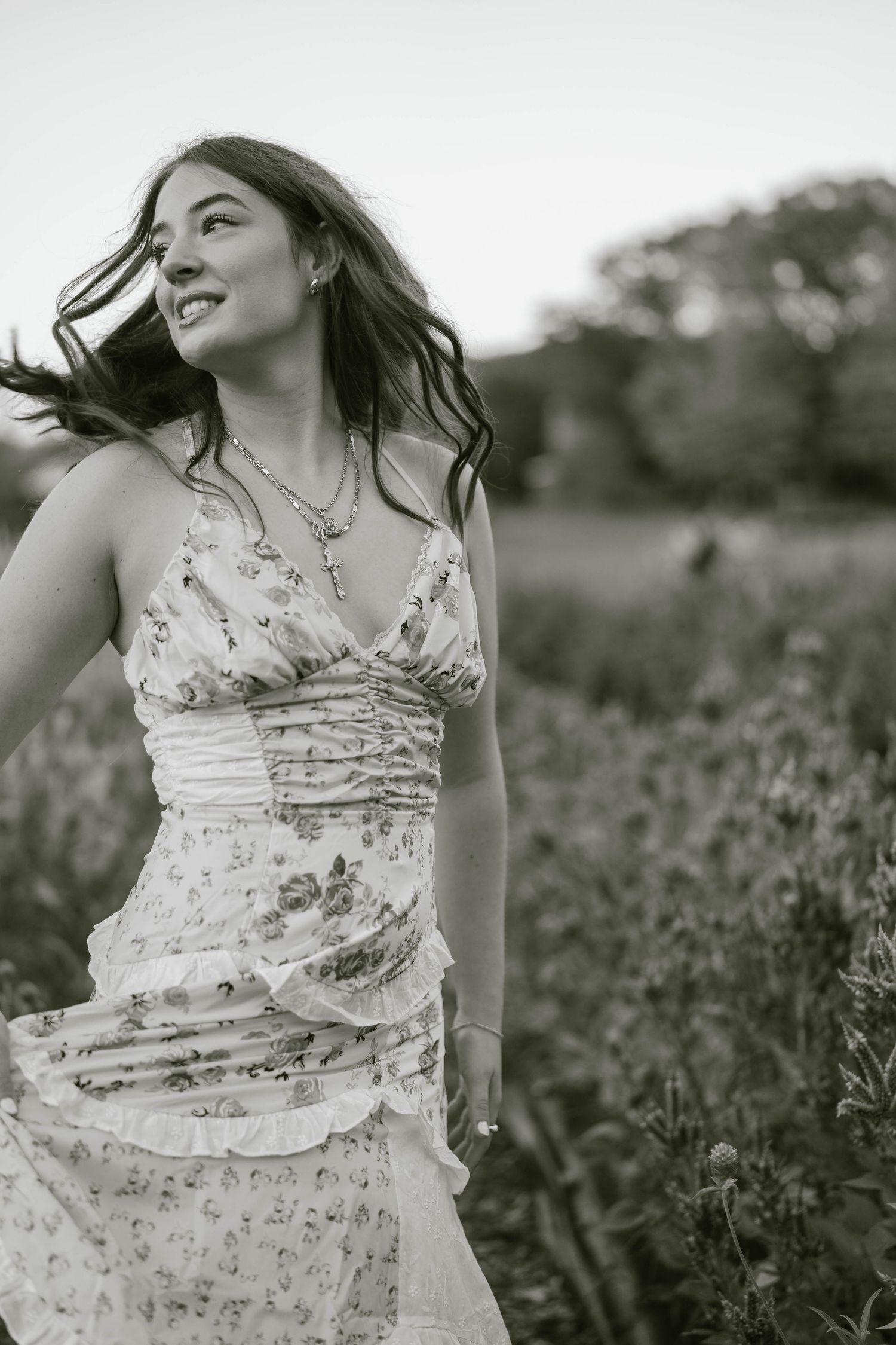 Teen twirling in a colorful meadow, captured in a candid senior session