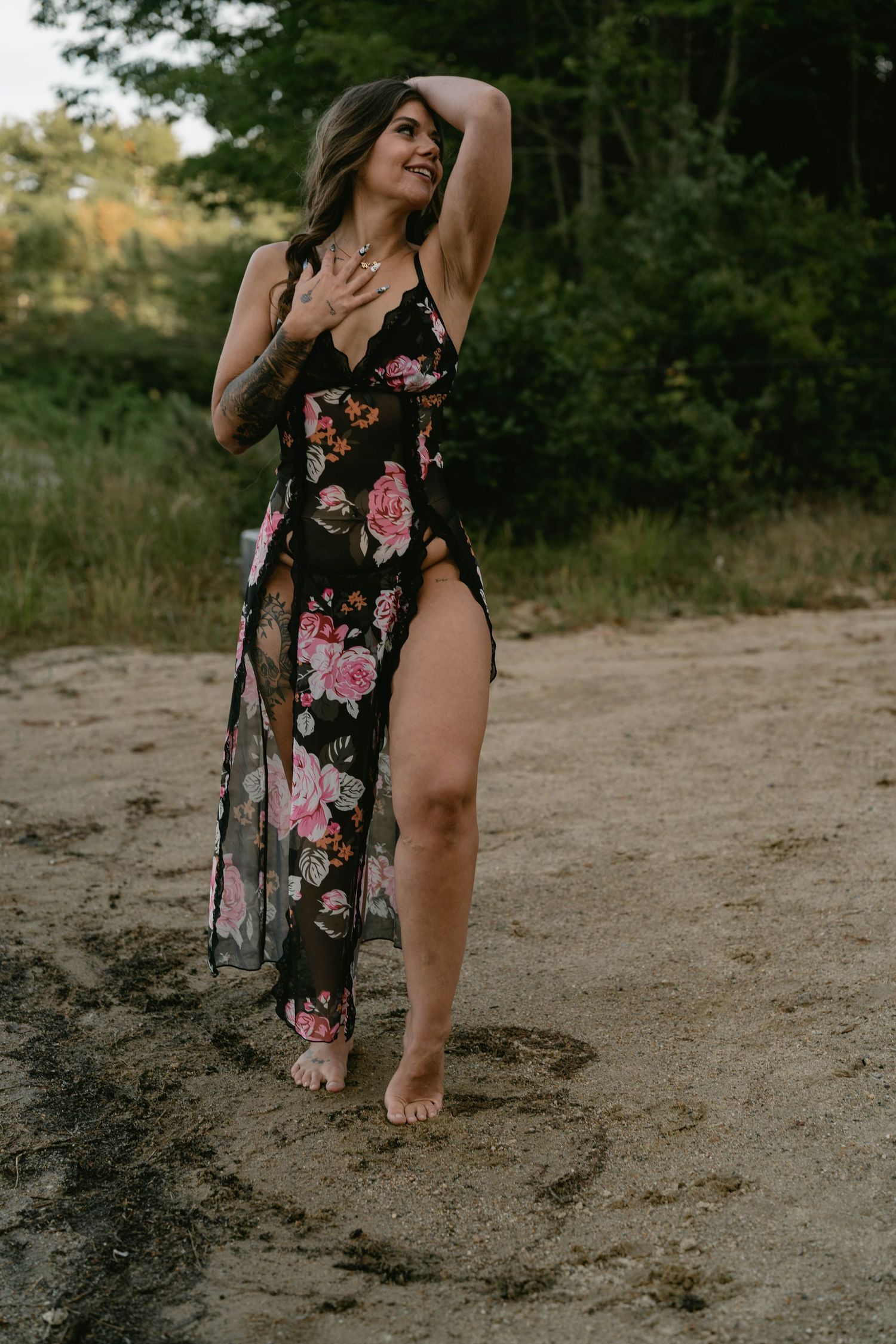 A floral dress photoshoot on a dirt path with natural outdoor lighting and greenery.