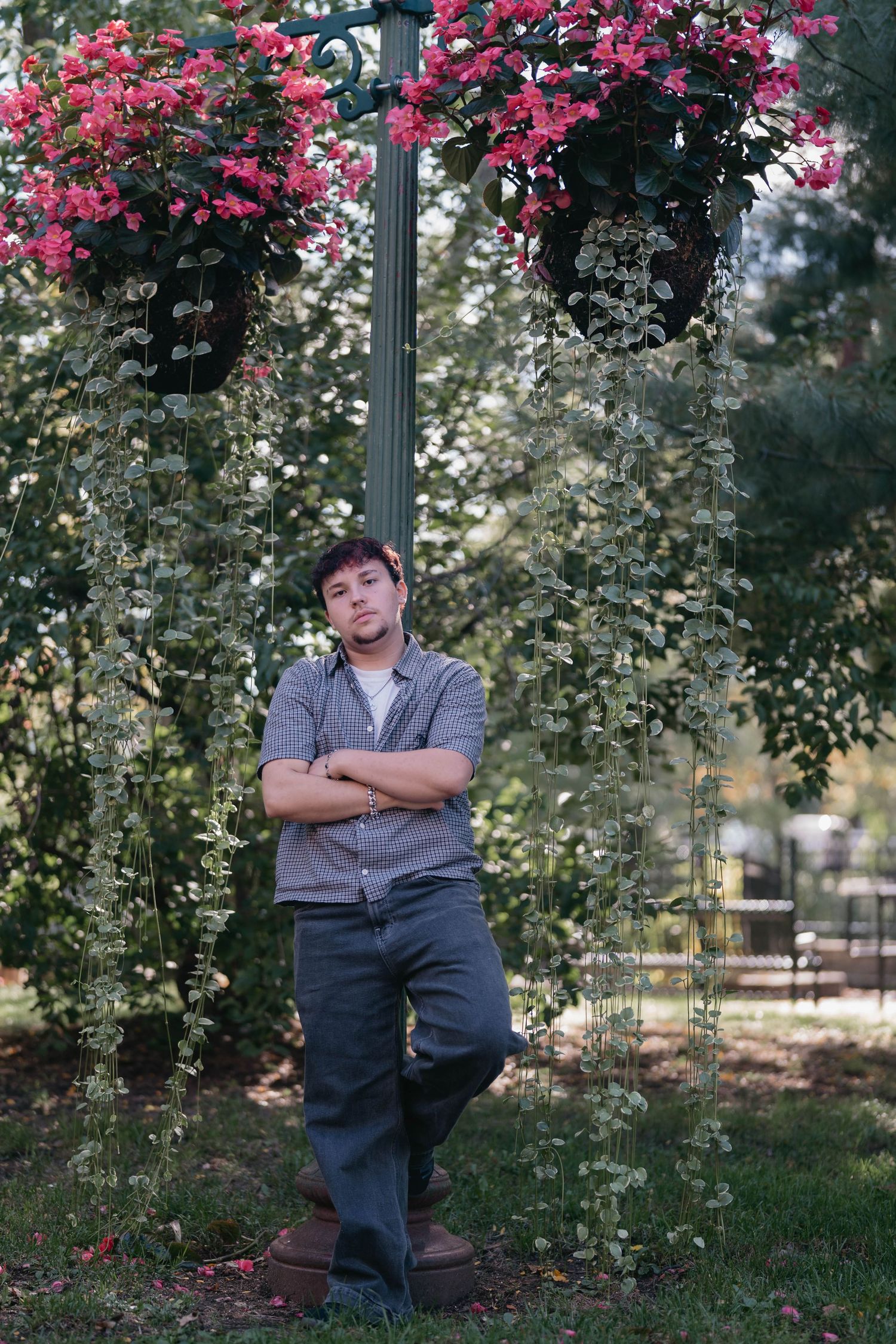 Senior standing on city sidewalk, smiling and enjoying a relaxed urban portrait session.