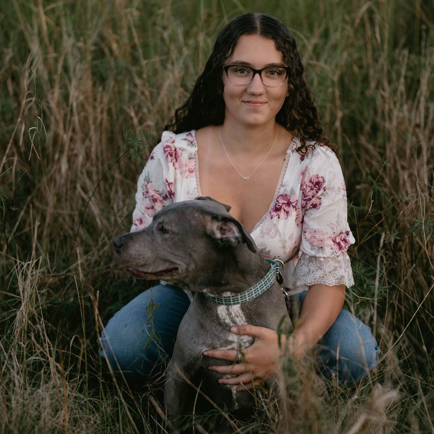 Senior lying in field with puppy, relaxed and joyful moment.