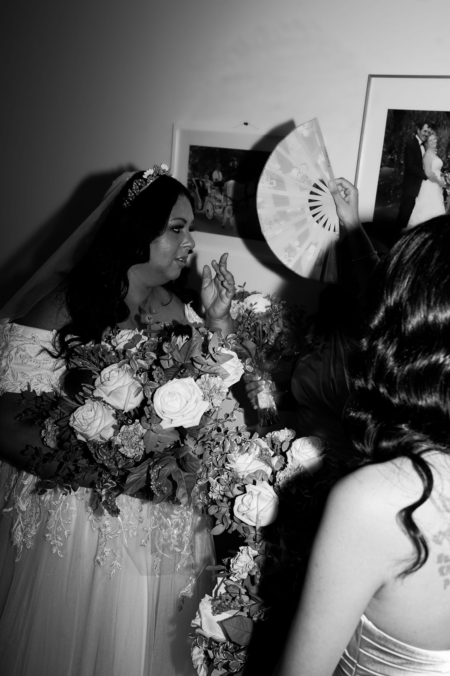 Black and white photo of an elegant wedding reception with floral decorations.