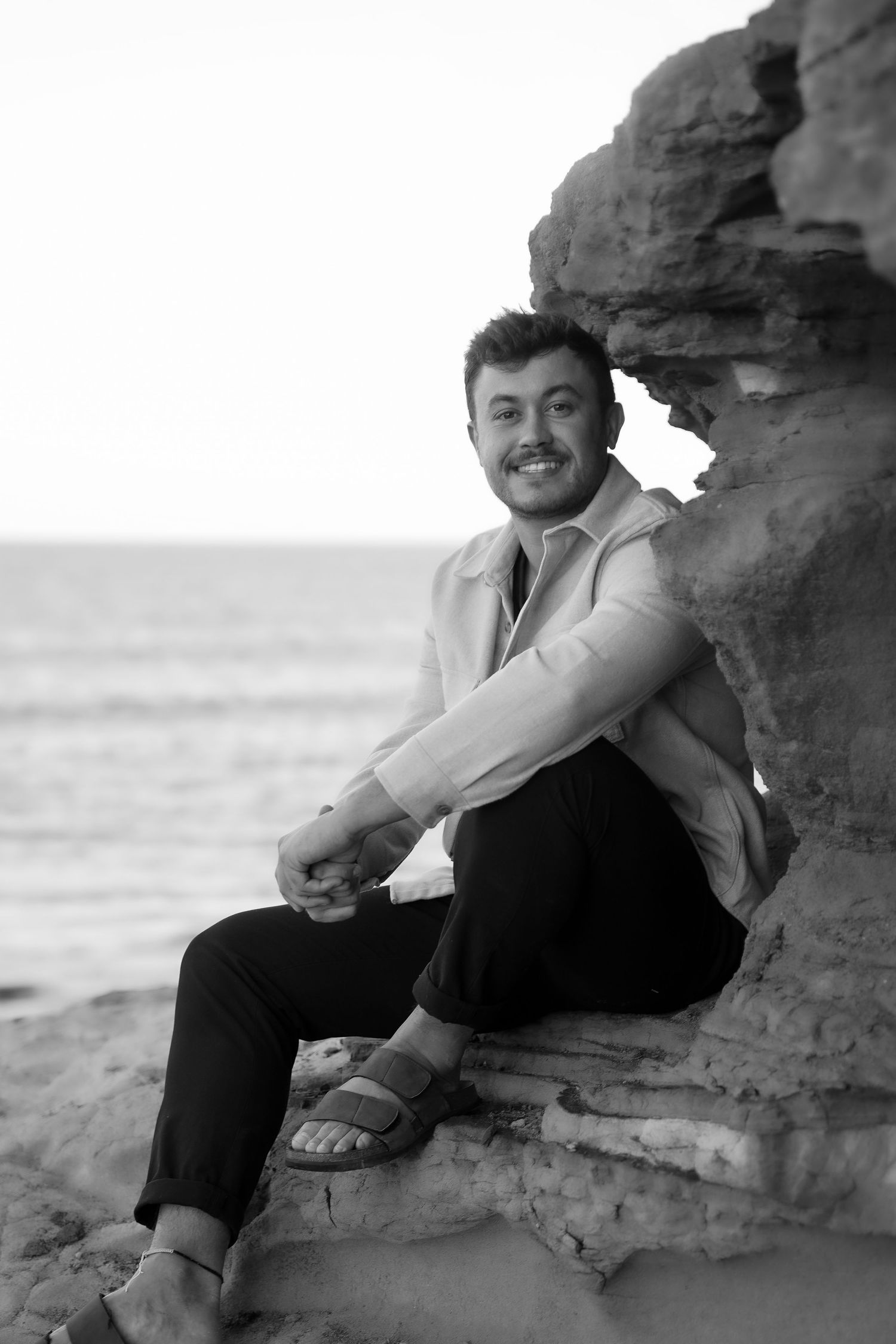 A black and white portrait session along coastal rock formations.