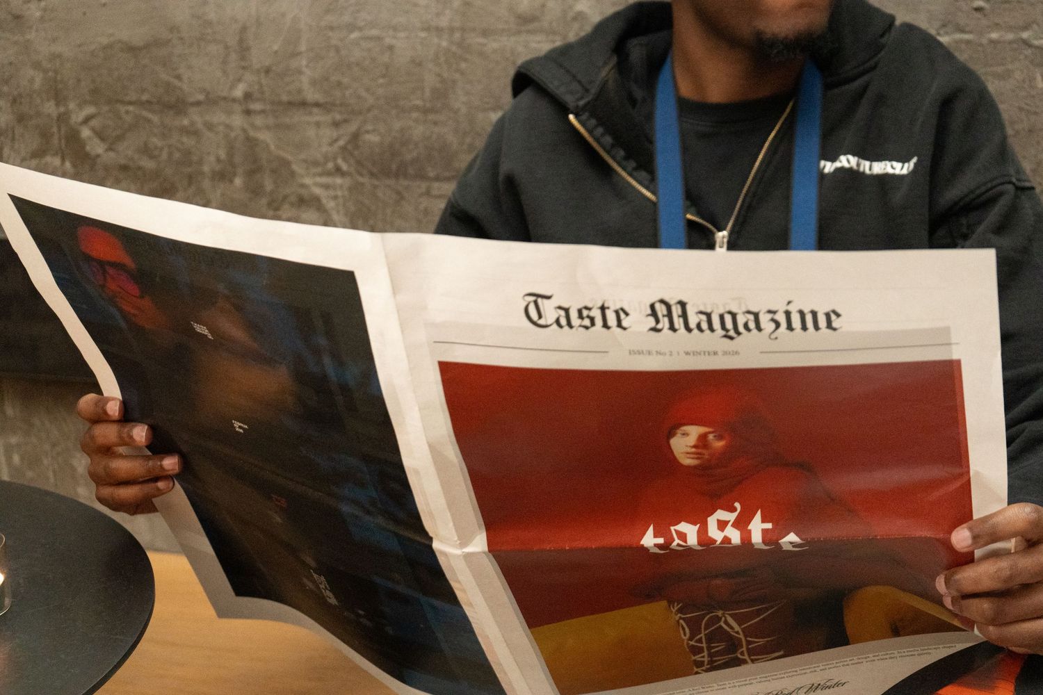 Person reading Taste Magazine with vibrant food photography on the cover page.