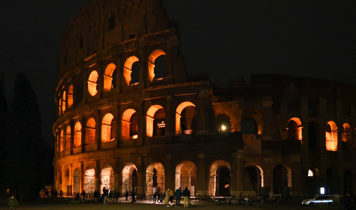 Night view of the illuminated Colosseum in Rome with glowing arches, travel photography, italy
