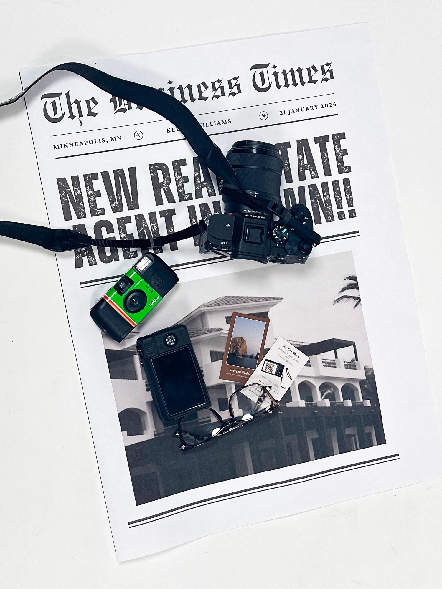 Flat lay of The Business Times newspaper with a DSLR camera, disposable camera, and photo prints on white background.