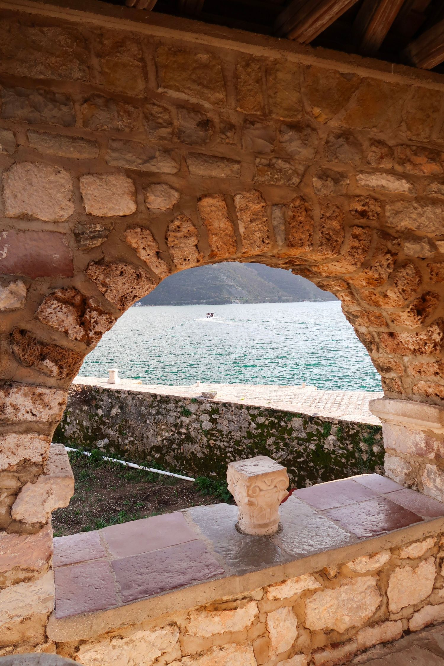 Stone archway windows overlooking the Mediterranean Sea through ancient fortress walls, montenegro,  travel photography
