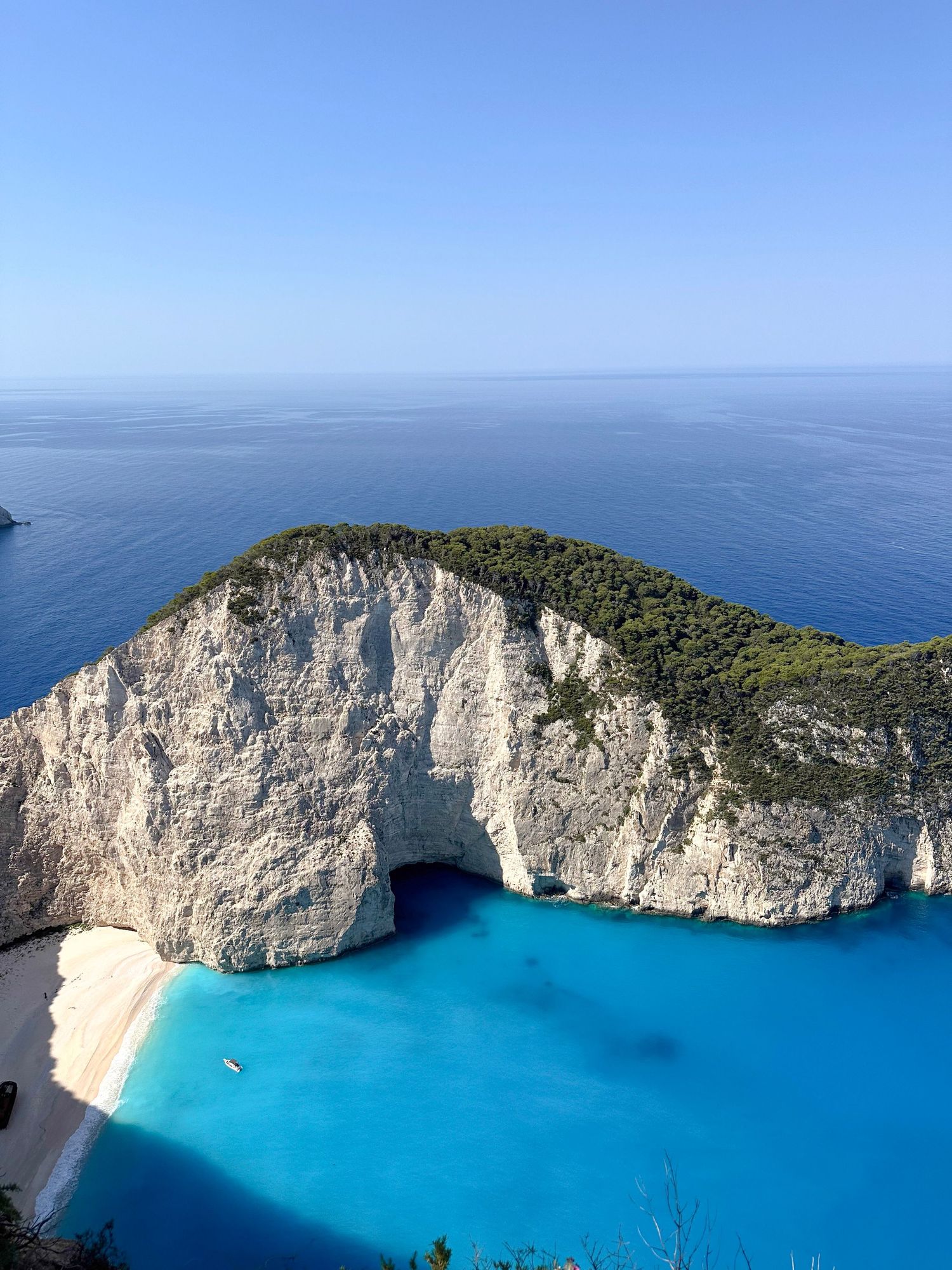 Stunning aerial view of Navagio Beach with white cliffs and turquoise waters in Zakynthos, Greece.