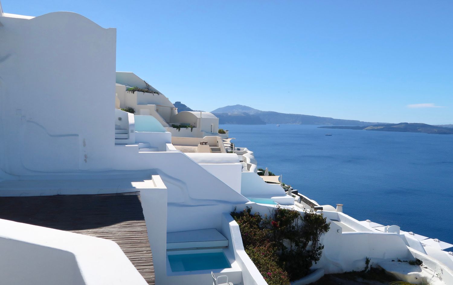 Panoramic view of white buildings and blue sea in Santorini, Greece, travel photography
