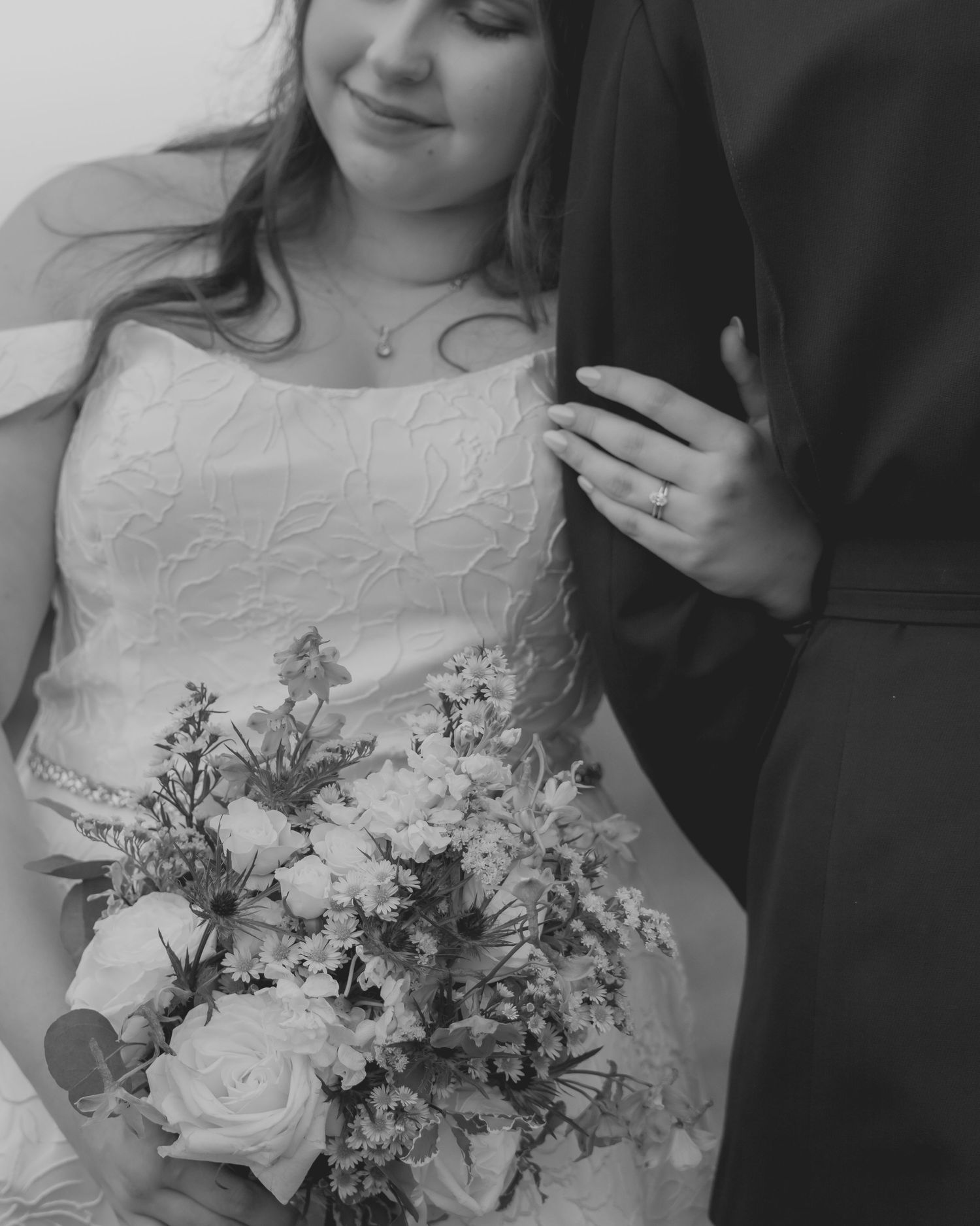 Black and white detail shots of bride's lace dress and floral bouquet.