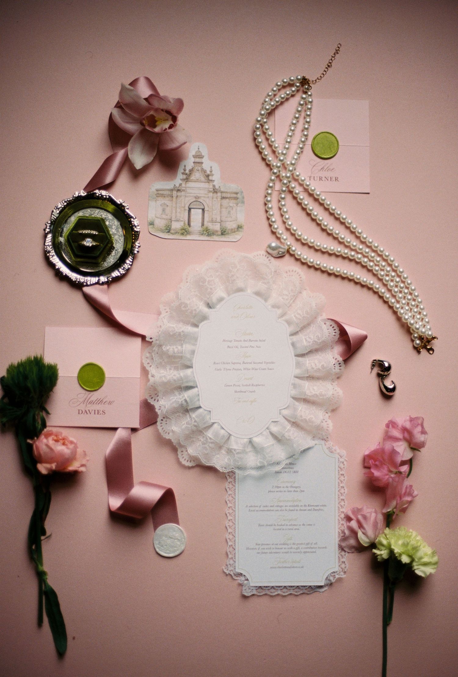 Assorted wedding decorations including flowers, ribbons, and a wedding invitation.