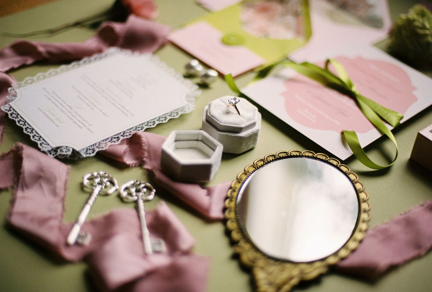 An assortment of sewing supplies, including scissors, a thimble, and a magnifying glass, arranged on a colorful fabric background.