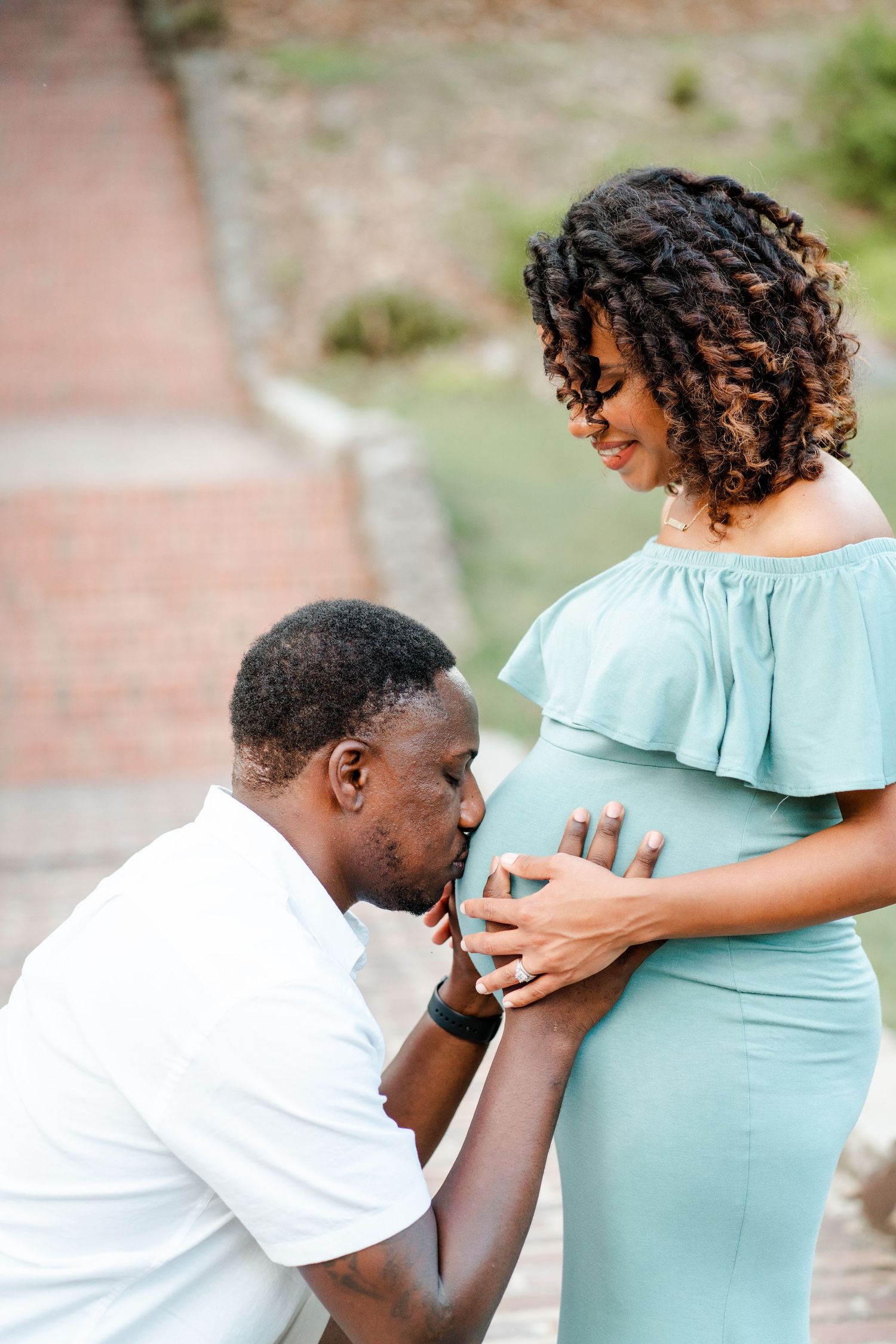 A series of maternity photos showing a couple in white and mint green outfits embracing the baby bump outdoors.