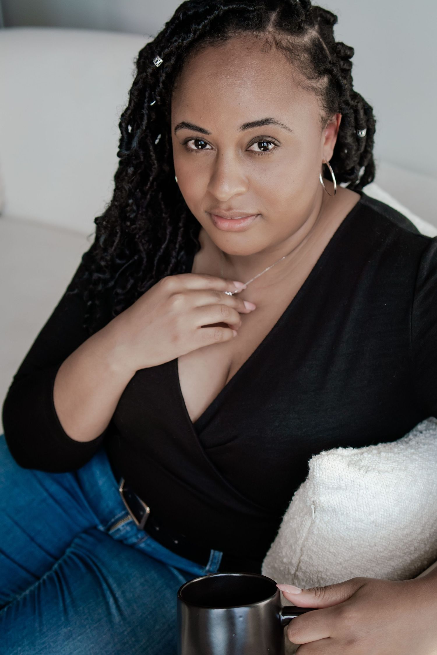 Casual indoor portrait series with black top and braided hairstyle.