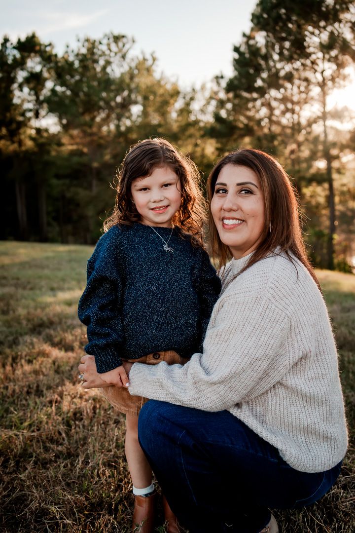 A heartwarming outdoor photo session at sunset showing tender moments between two people in a grassy field.
