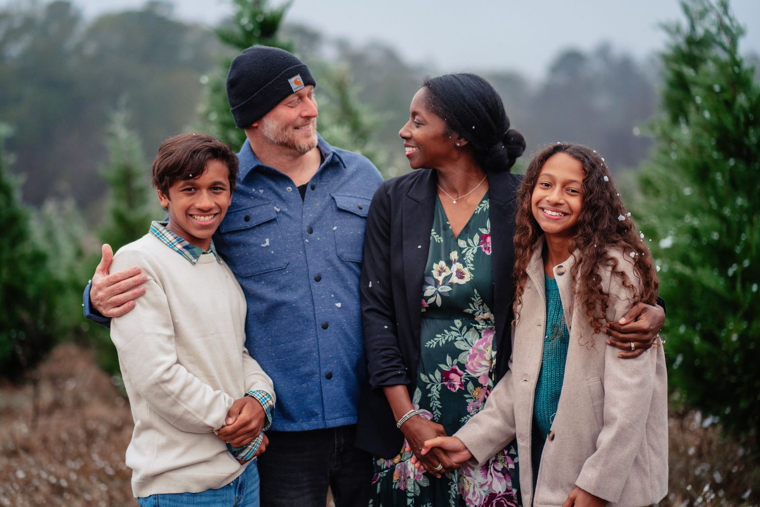 A family shares joyful moments together outdoors during a casual photo session in nature.