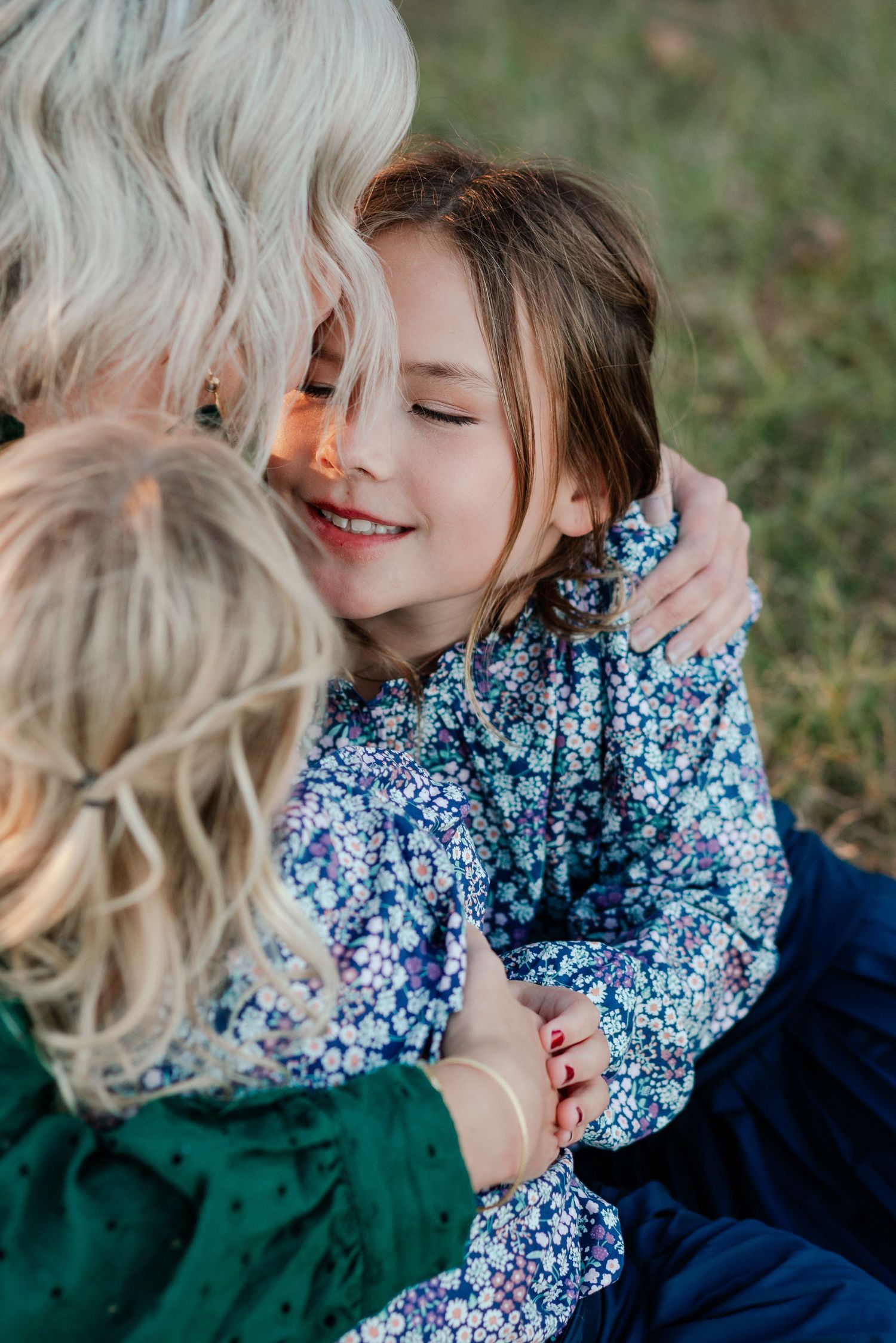 Close-up of an affectionate embrace between two people wearing floral patterns.