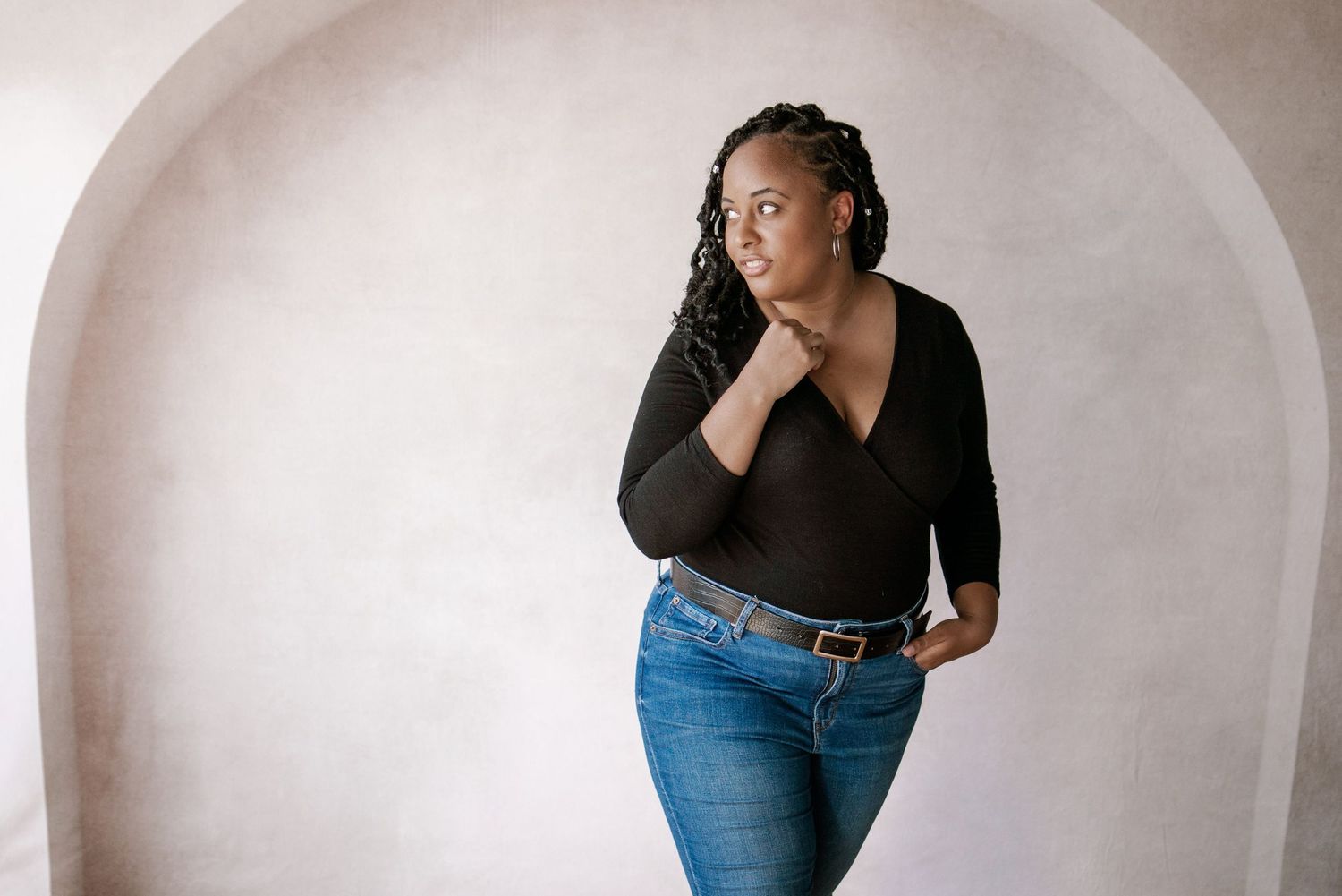 Minimalist portrait series against white curved wall background.