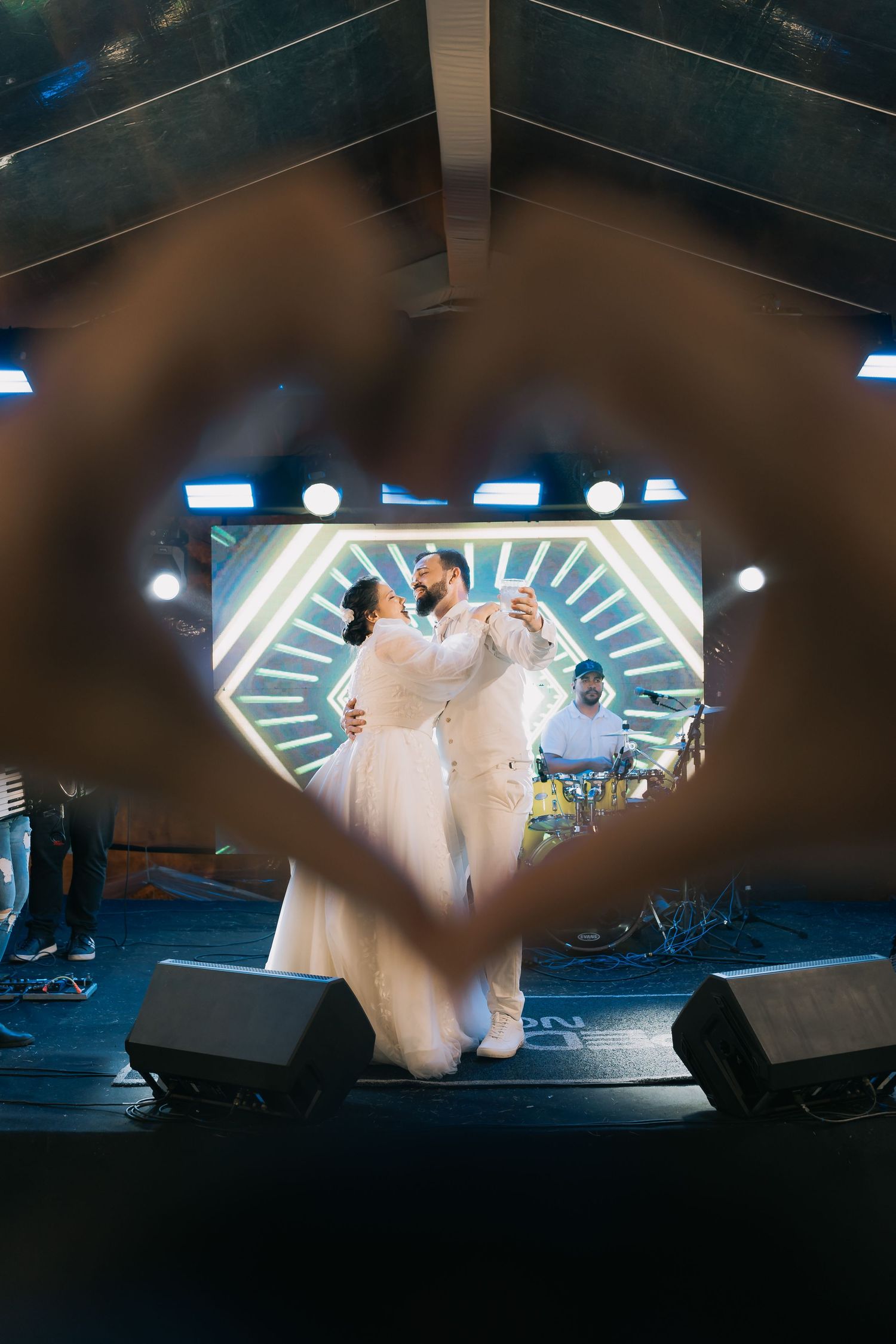 Low-angle view of wedding celebration with dramatic lighting and stage setup.