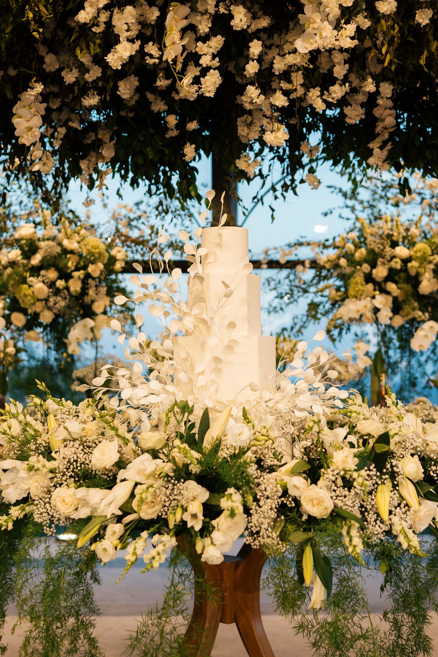 Elegant floral arrangement with white blooms and greenery creating a romantic overhead display.