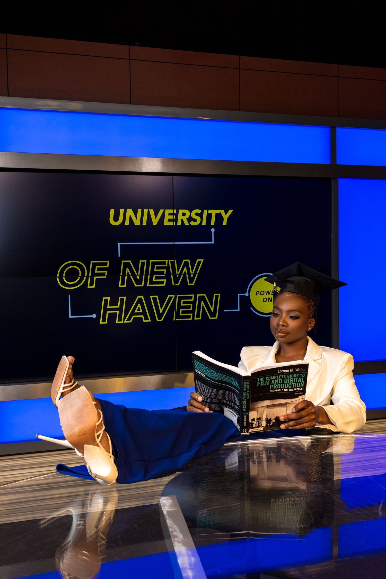 University signage with modern lighting design creating depth and dimension.