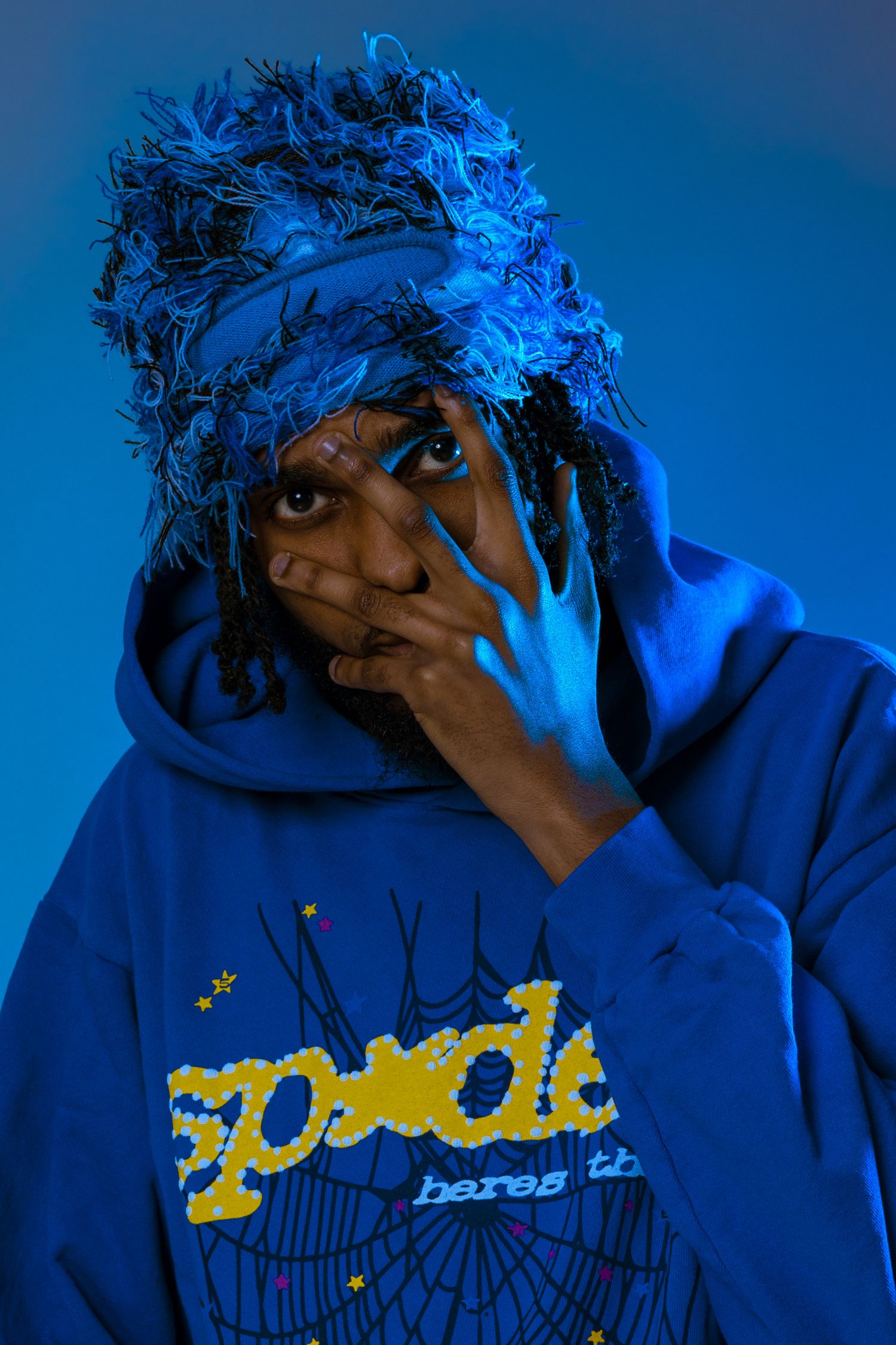 Artistic portrait series with dramatic blue lighting and shadows creating a moody atmosphere.