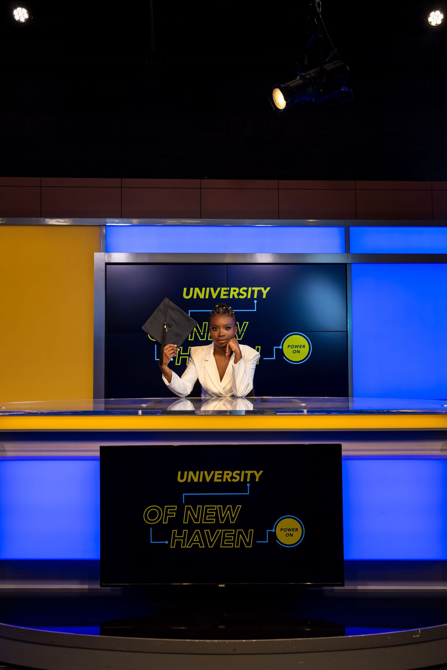University of New Haven signage illuminated against dark background with blue accent lighting.