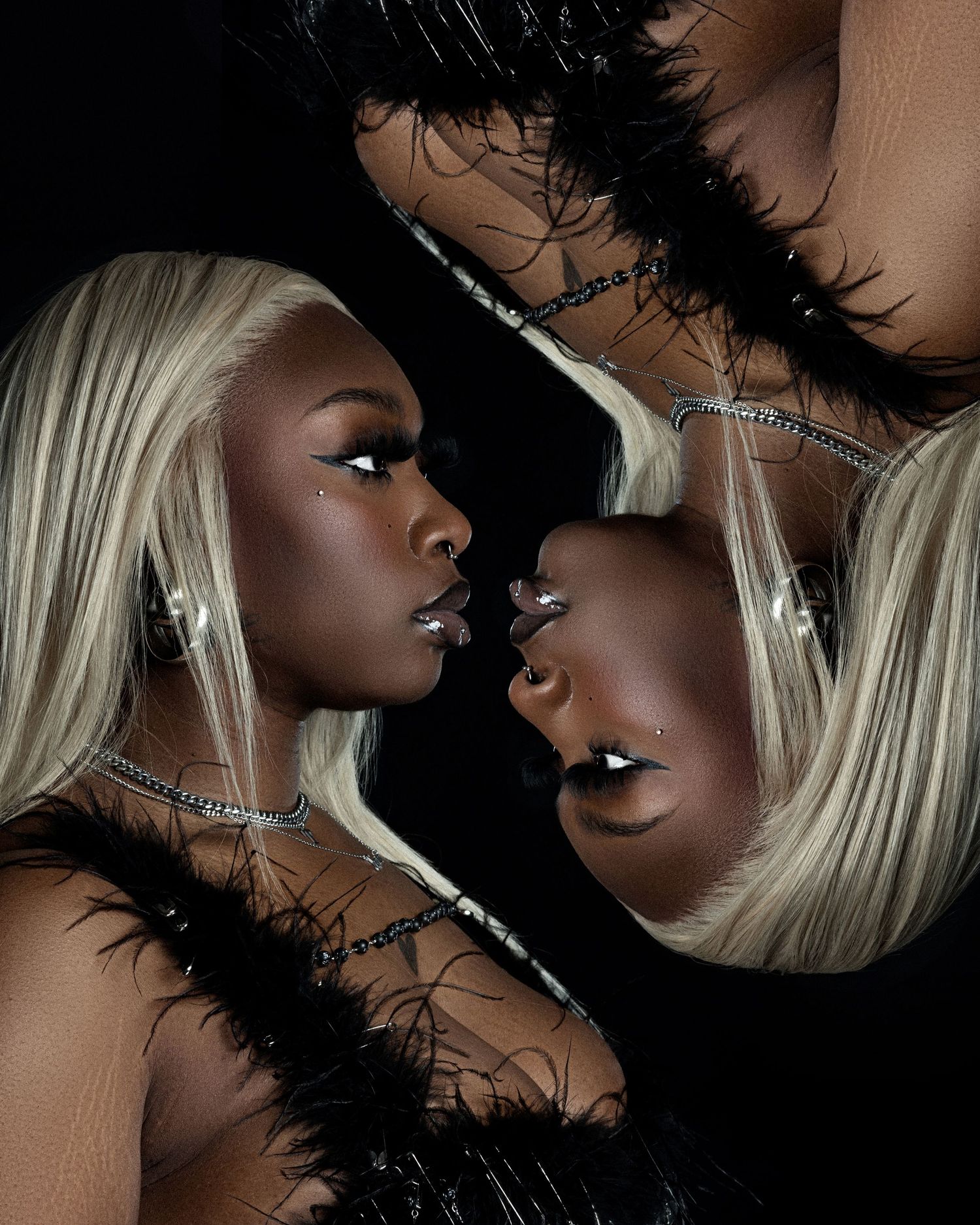 Dramatic beauty portrait with platinum blonde hair and feather accessories against dark background.