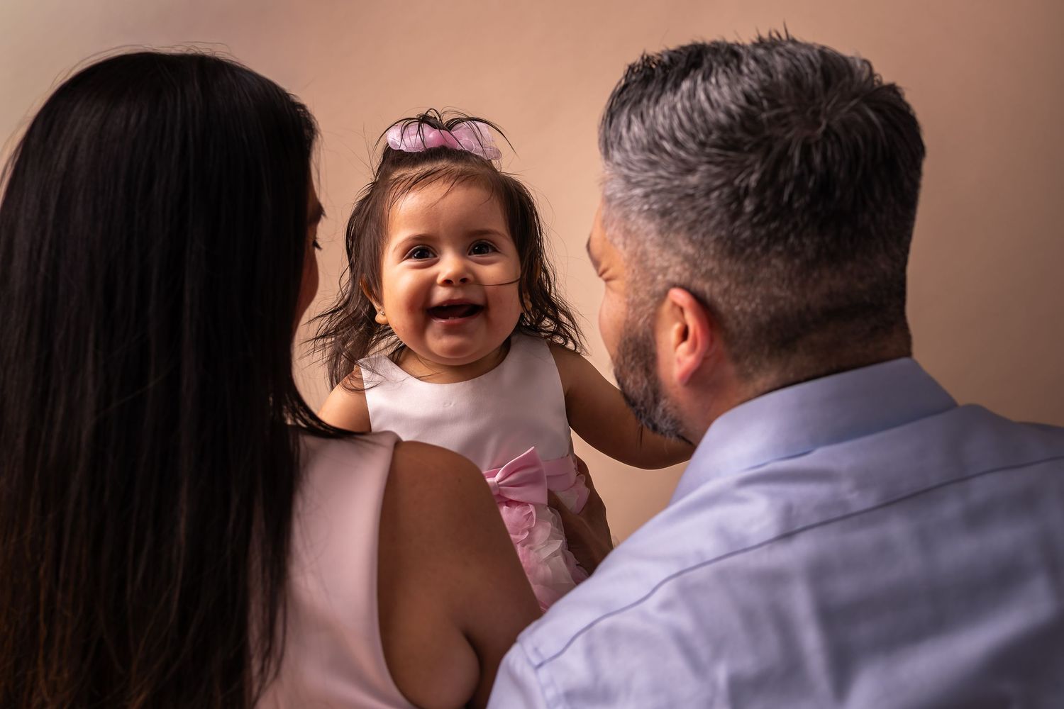 A series of four candid family moments showing parent and child interactions in warm, natural lighting.