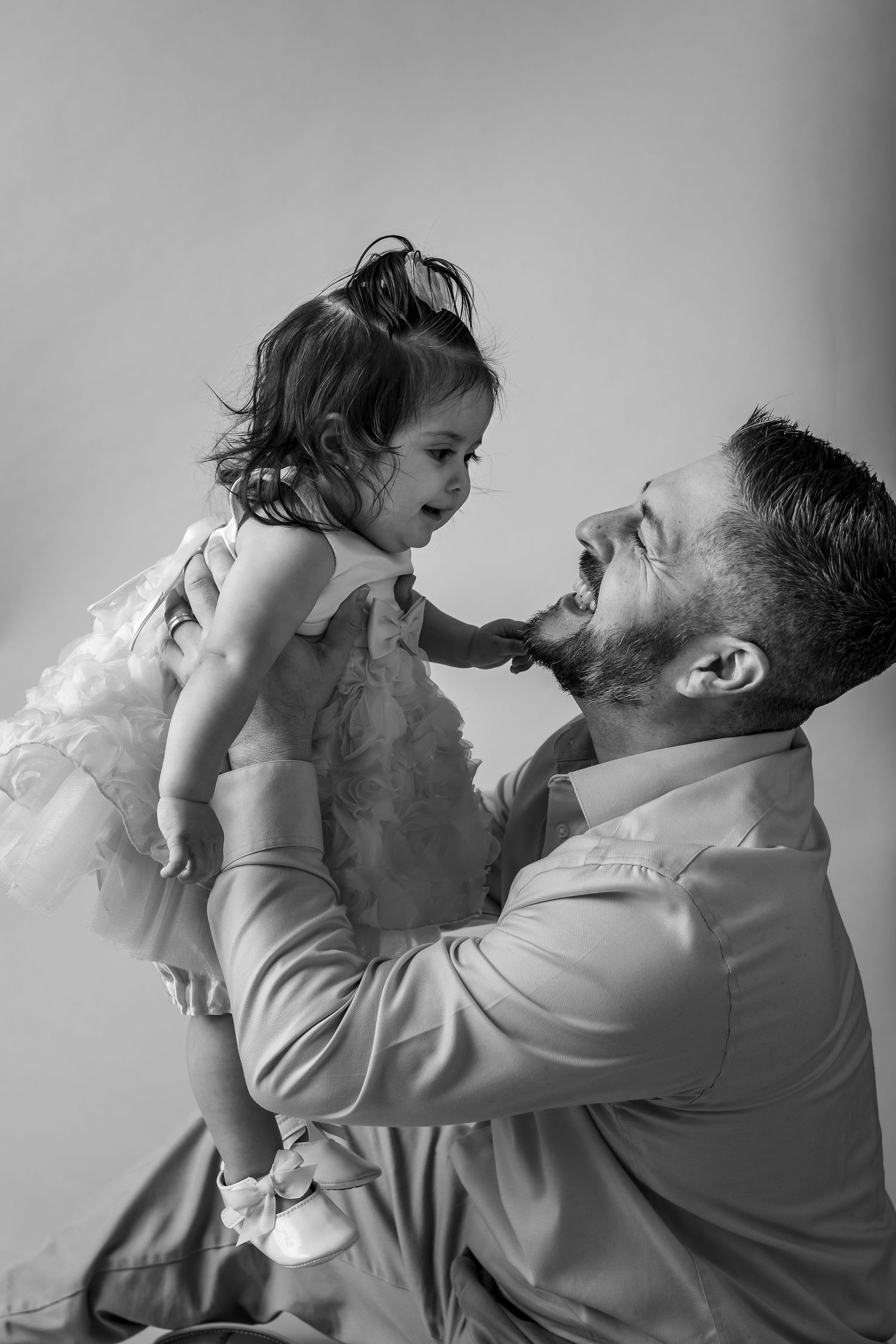 A heartwarming black and white photo sequence shows a parent and child sharing playful moments together.