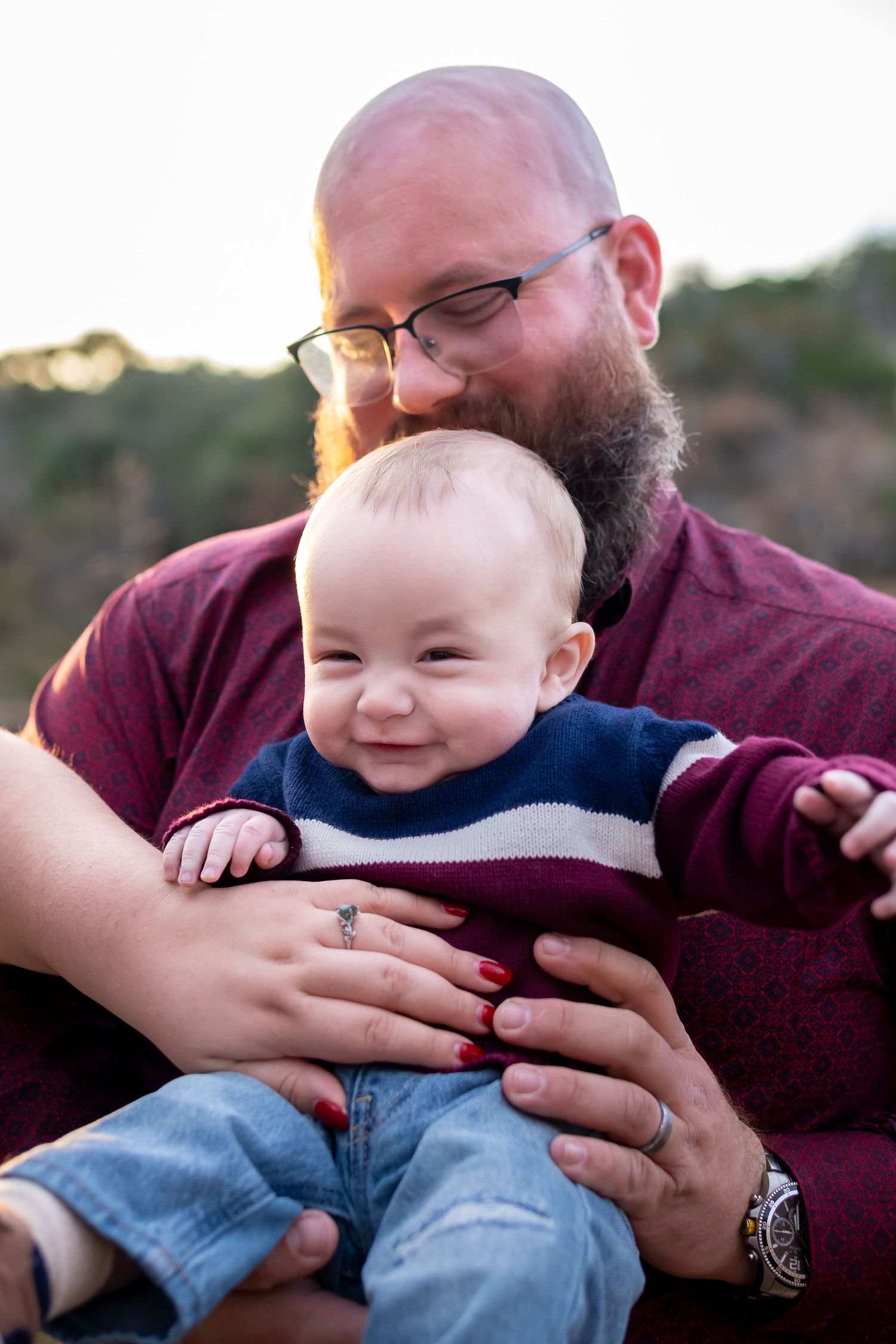 A heartwarming series of candid moments showing playful tickles and giggles between parent and child outdoors at sunset.