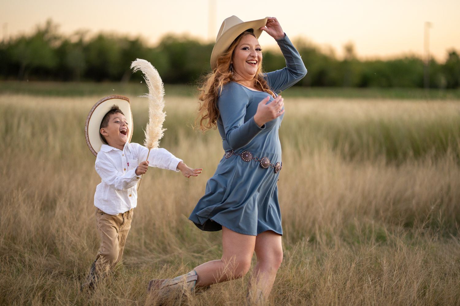 A joyful moment captured in a golden wheat field at sunset.