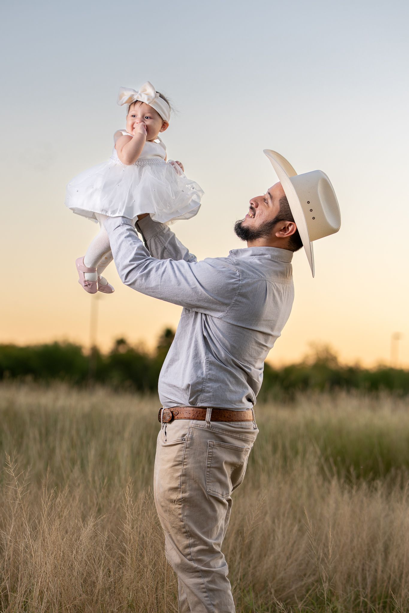 Playful poses in a sunlit field with dramatic lighting.