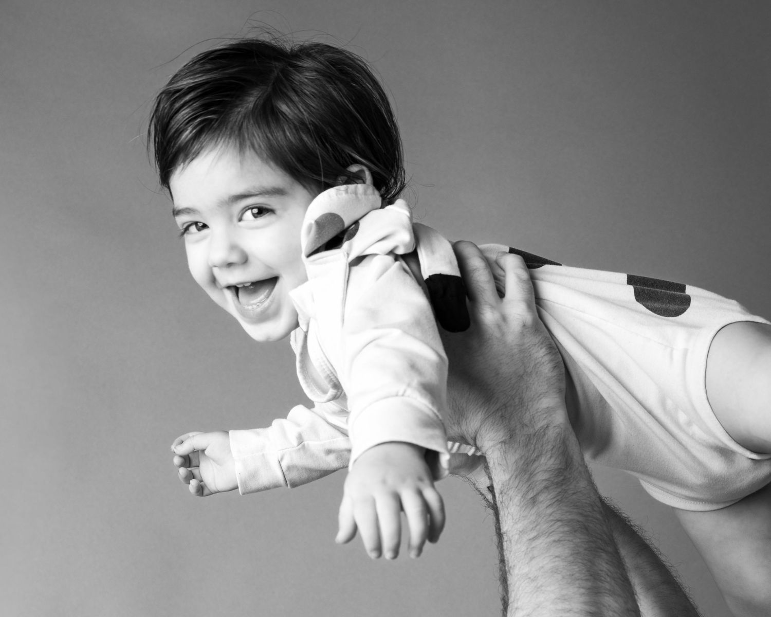 A series of black and white photos showing someone performing a dramatic martial arts or dance sequence.