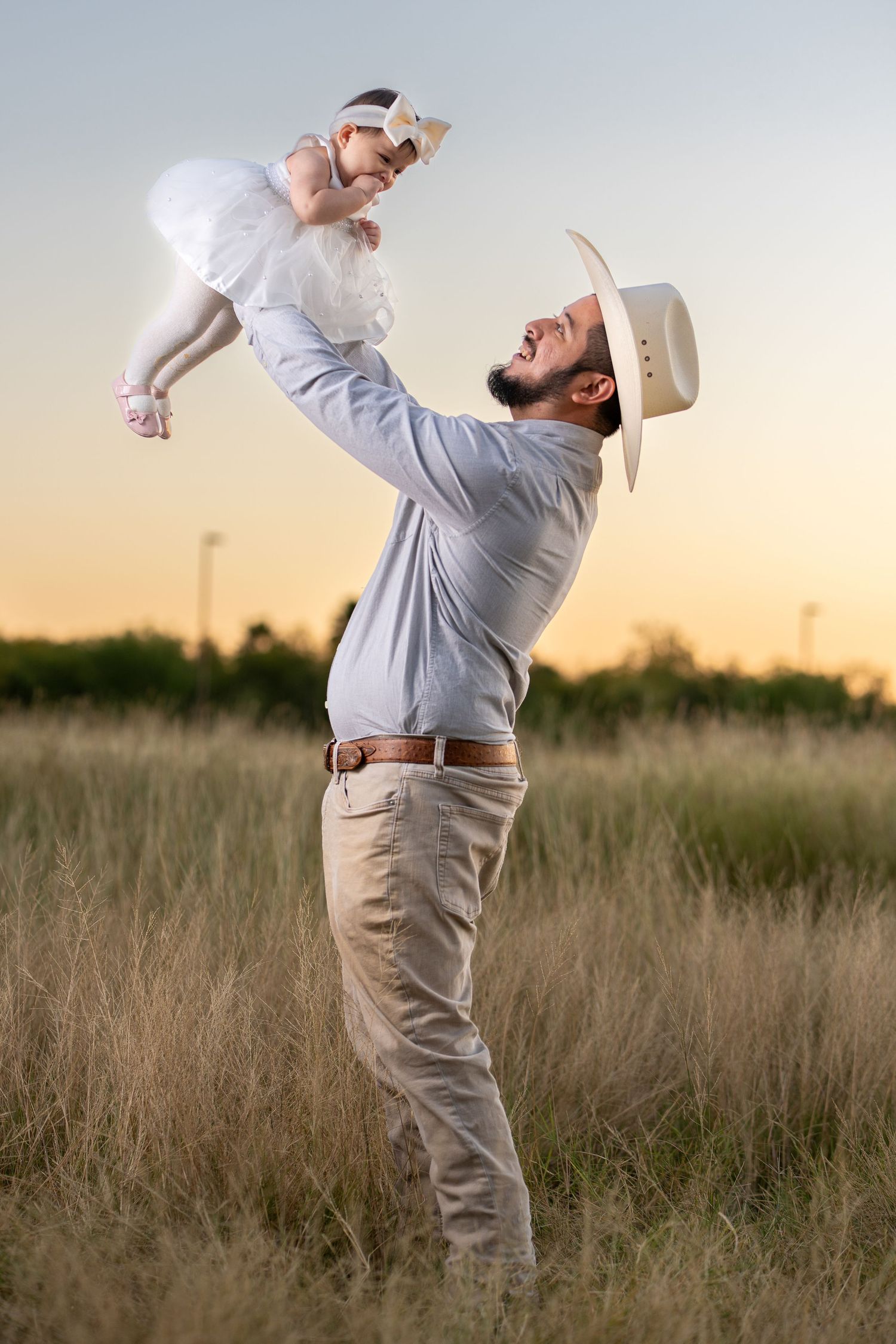 A sequence of photos showing a person in a light shirt and khakis leaning backwards dramatically in a grassy field at sunset.