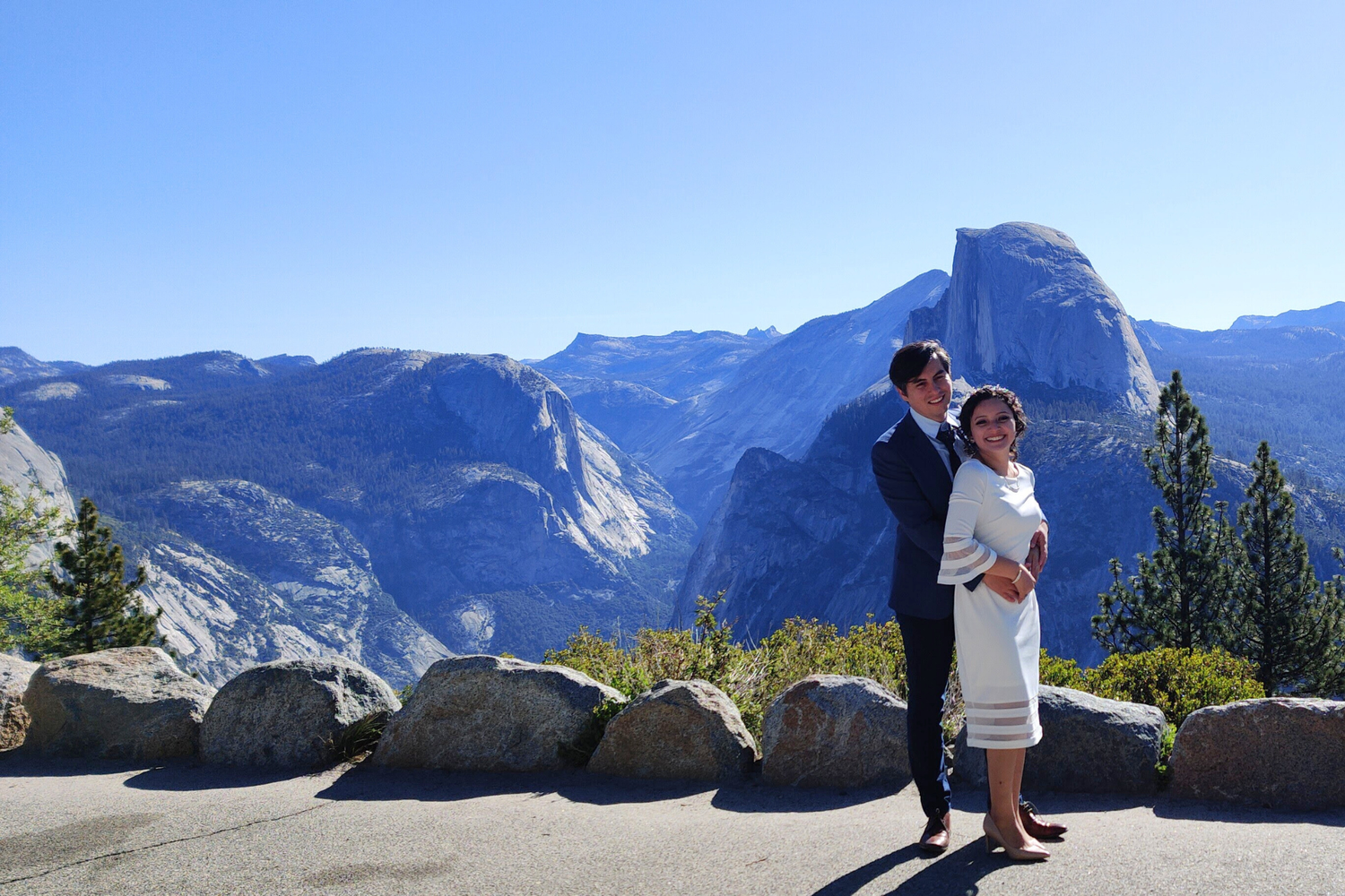 A couple getting married at Glacier Point in Yosemite National Park with Half Dome visible in background.